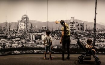 Une mère et deux enfants au Hiroshima Peace Memorial Museum voient un côté panoramique à grande échelle de demande de bombe nucléaire à Hiroshima
